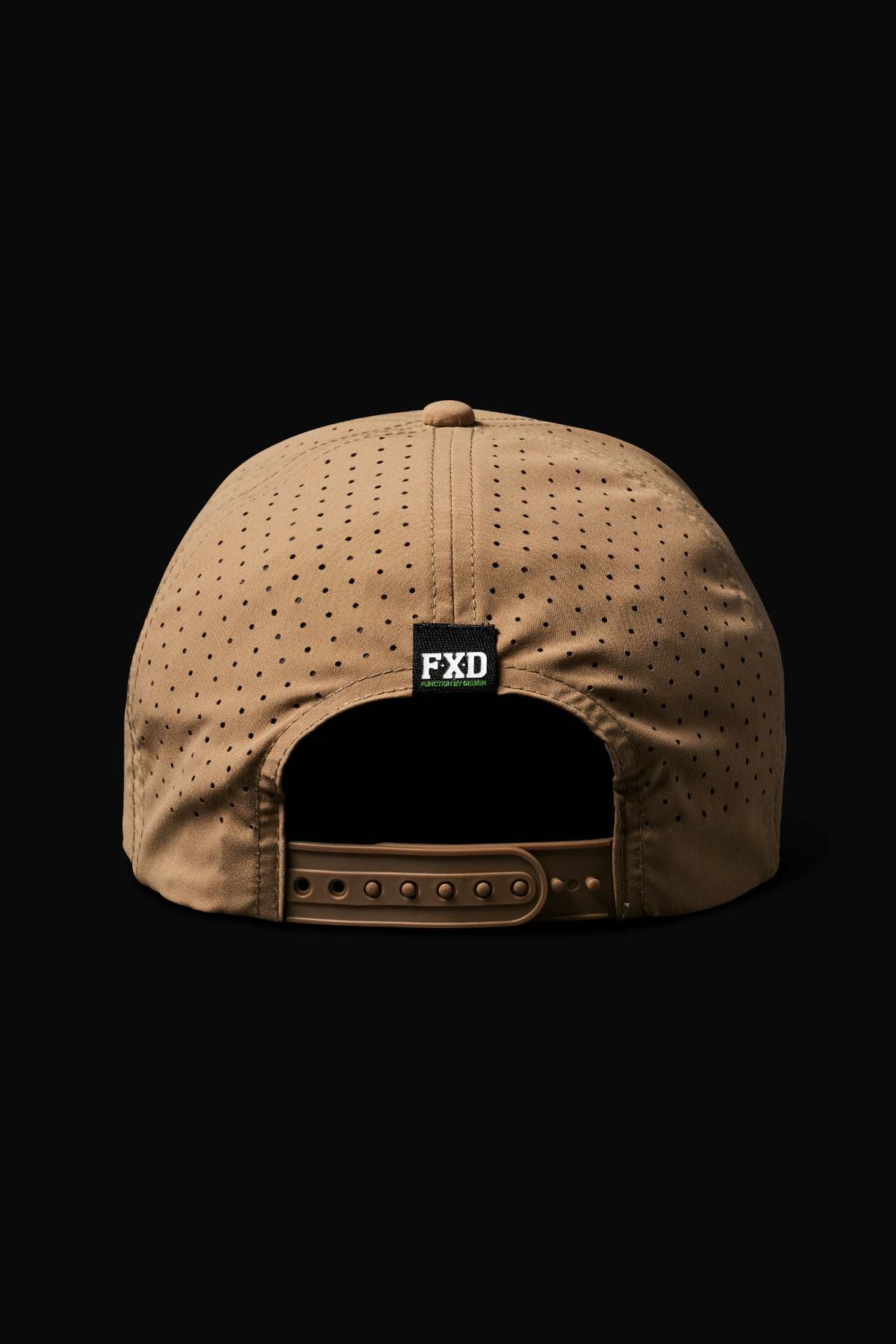 The FXD CP-12 Tech Baseball Cap is shown from the back, highlighting a brown perforated design, adjustable snap-back closure, and a small black and green FXD logo label. Made from quick-drying performance polyester, set on a black background.
