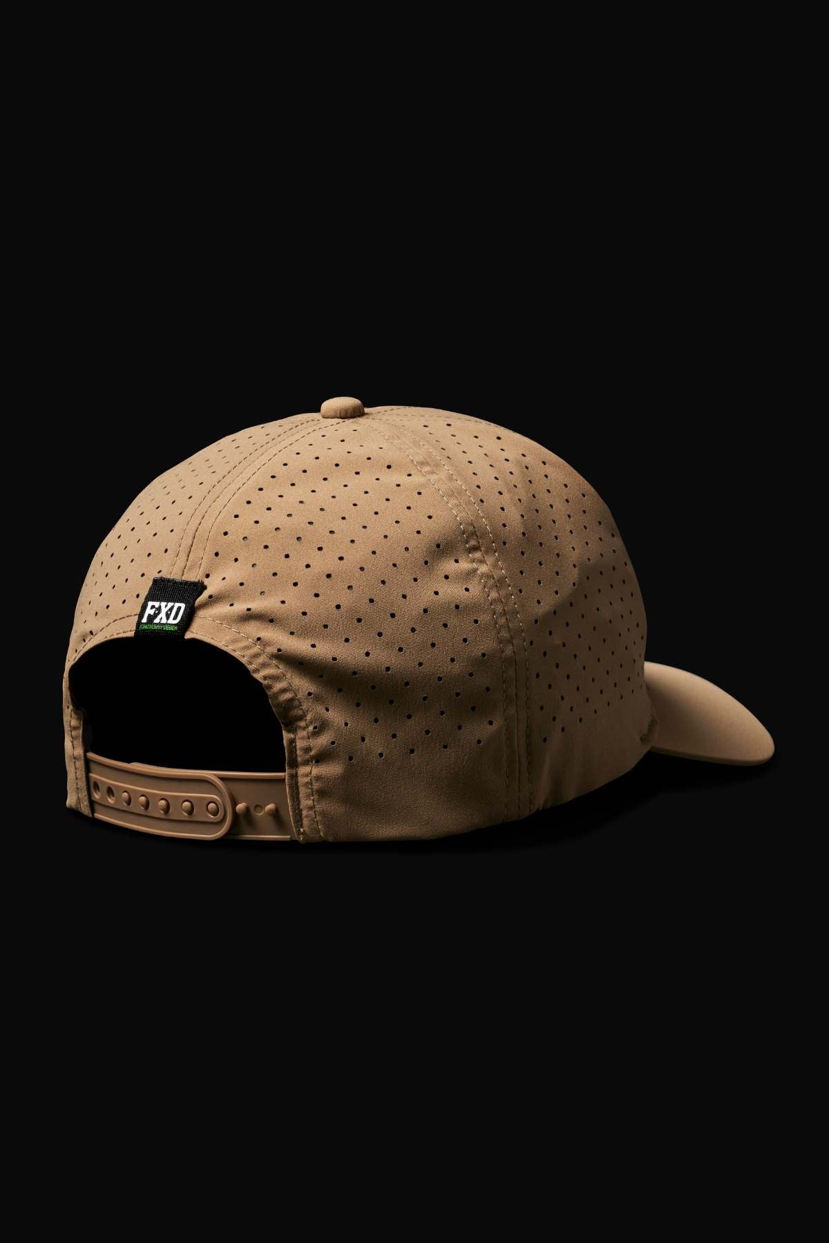 The FXD CP-12 Tech Baseball Cap in tan features perforated holes for breathability, an adjustable snap-back, a black "FXD" tag above the opening, and is made from quick-drying performance polyester; shown back view on black.