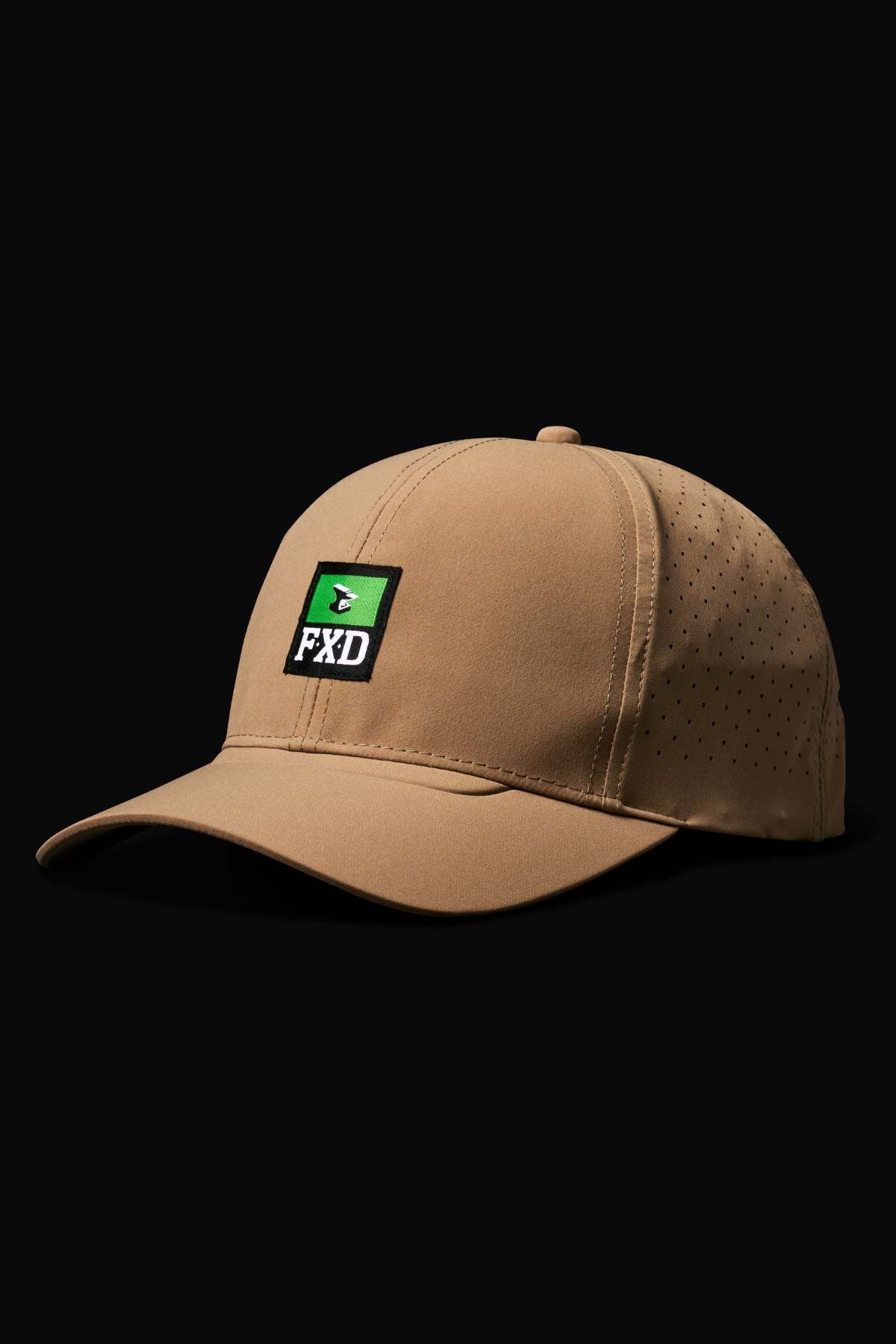 The FXD CP-12 Tech Baseball Cap in tan features quick-drying polyester, side ventilation holes, adjustable snap-back, and a black patch with green triangle and white "FXD." Displayed on a black background.