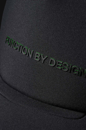 Close-up of the FXD CP-13 Trucker Cap’s black, breathable fabric with raised black “FUNCTION BY DESIGN” lettering embossed on the surface.