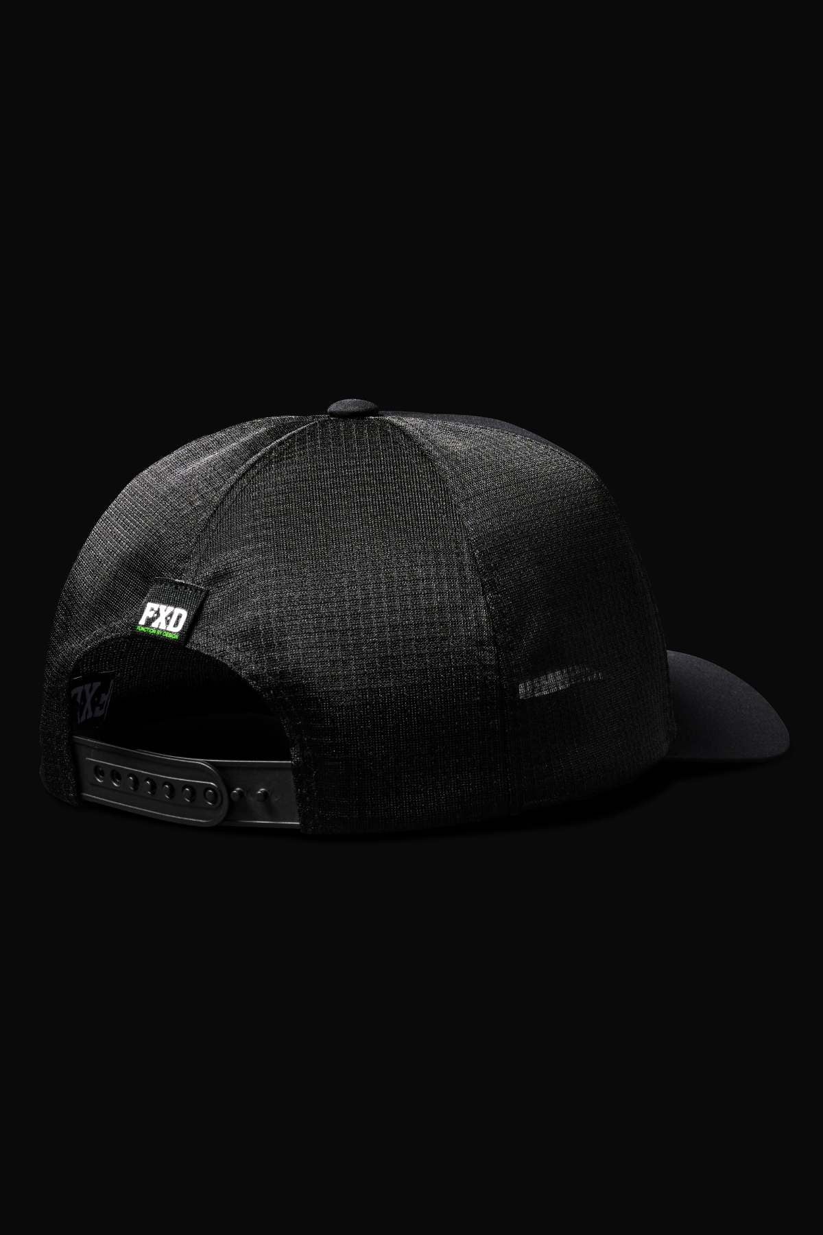 The FXD CP-13 Trucker Cap is shown from the rear, featuring a breathable black design, adjustable snap-back strap, and a small green FXD label against a solid black background.
