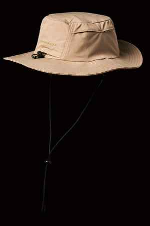 The FXD CP-14 Boonie Hat, in beige with a wide brim, chin strap, and side ventilation holes for sun protection, stands out against a black background.