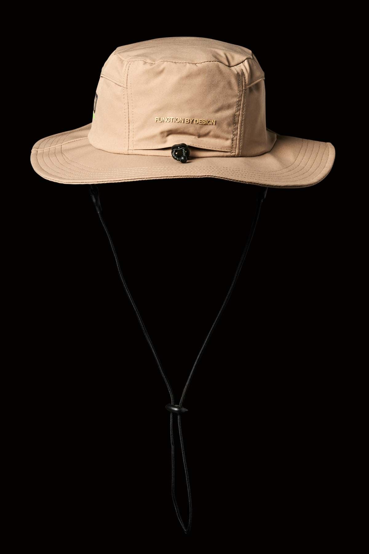 The FXD CP-14 Boonie Hat is beige with a wide brim, an adjustable black chin strap, and a small emblem on the front. It offers quick-drying sun protection against a black background, perfect for any adventure.
