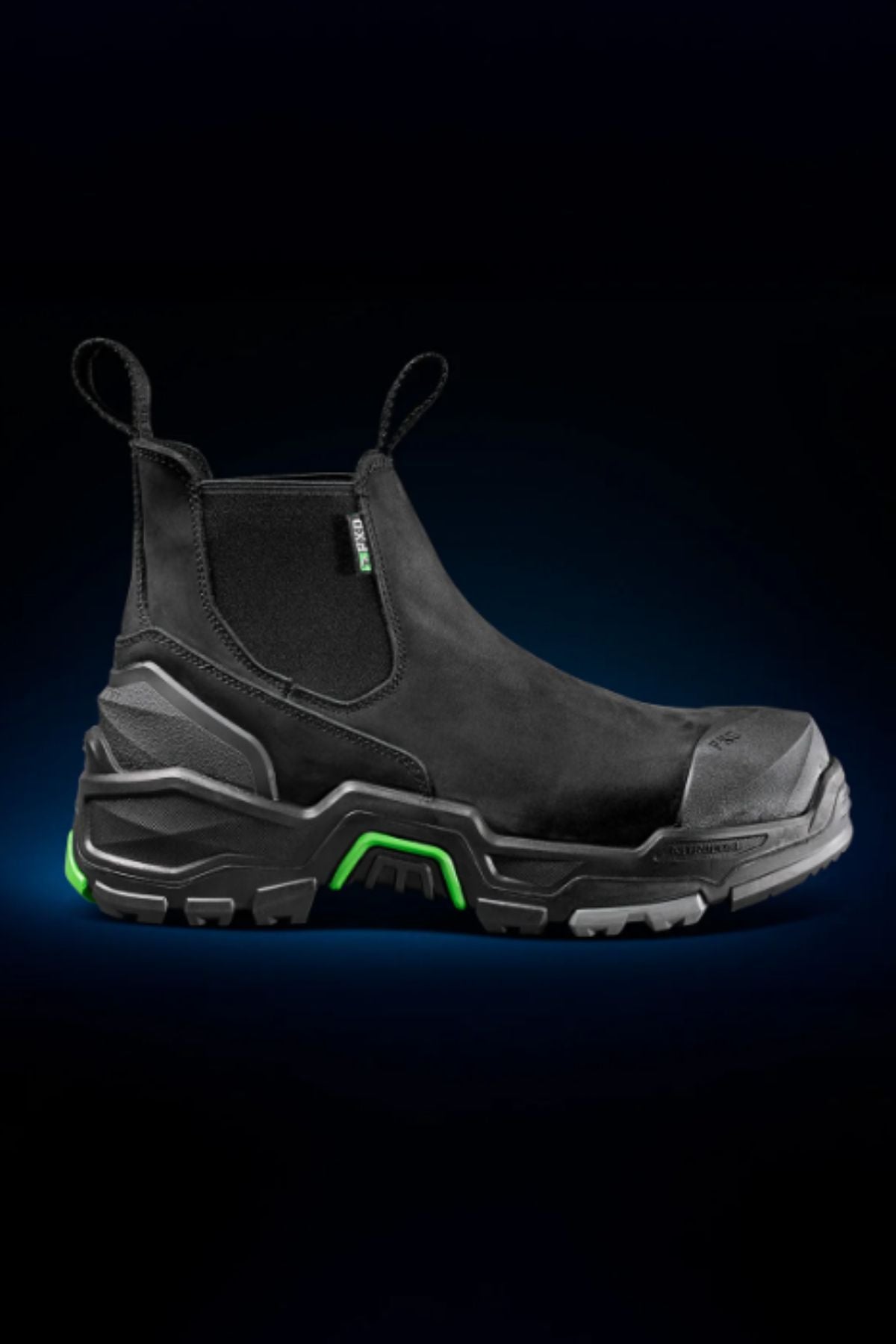 The FXD DURA X-3 Slip On Work Boots are rugged black industrial boots with a thick, textured sole, green accents, reinforced toe, and two pull tabs at the top, shown against a dark gradient background.