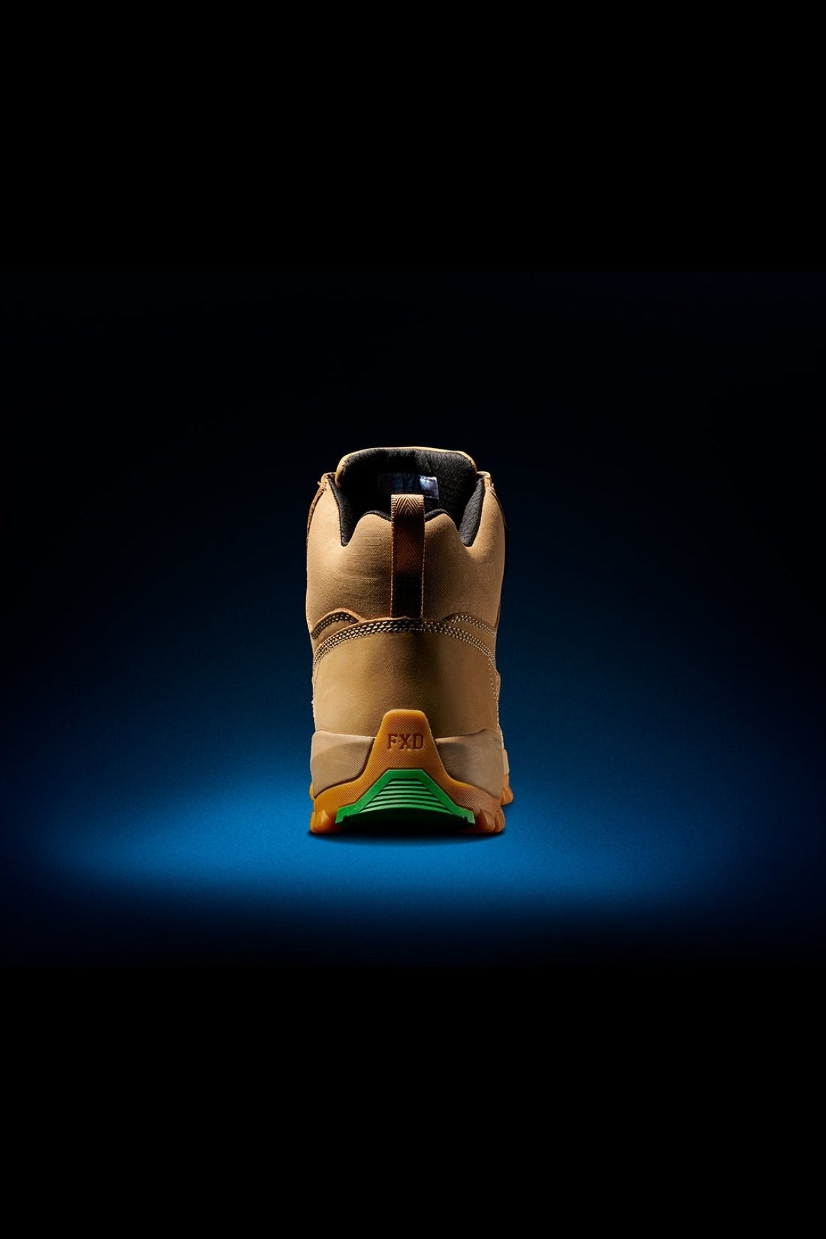The FXD WB-3 Work Boot is showcased against a dark background, highlighting its rugged sole and premium leather upper. The green tread and safety toe construction emphasize its durability for outdoor adventures.