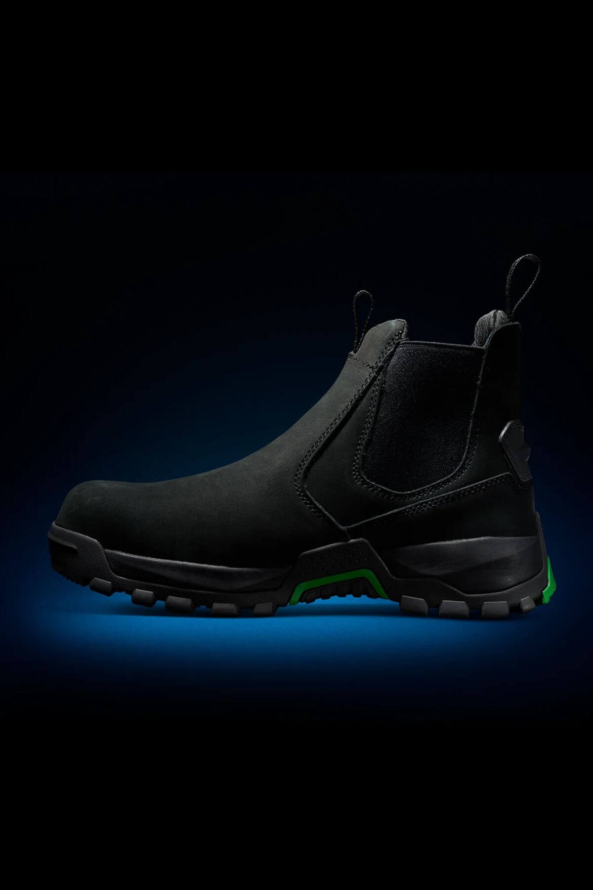 The FXD WB-4 Work Boot, a black high-top crafted from Nubuck leather with a rugged sole, is showcased against a dark background with a subtle blue glow. This boot features a pull tab on the back and boasts a reinforced safety toe, highlighting its sturdy and durable design ideal for heavy-duty tasks.