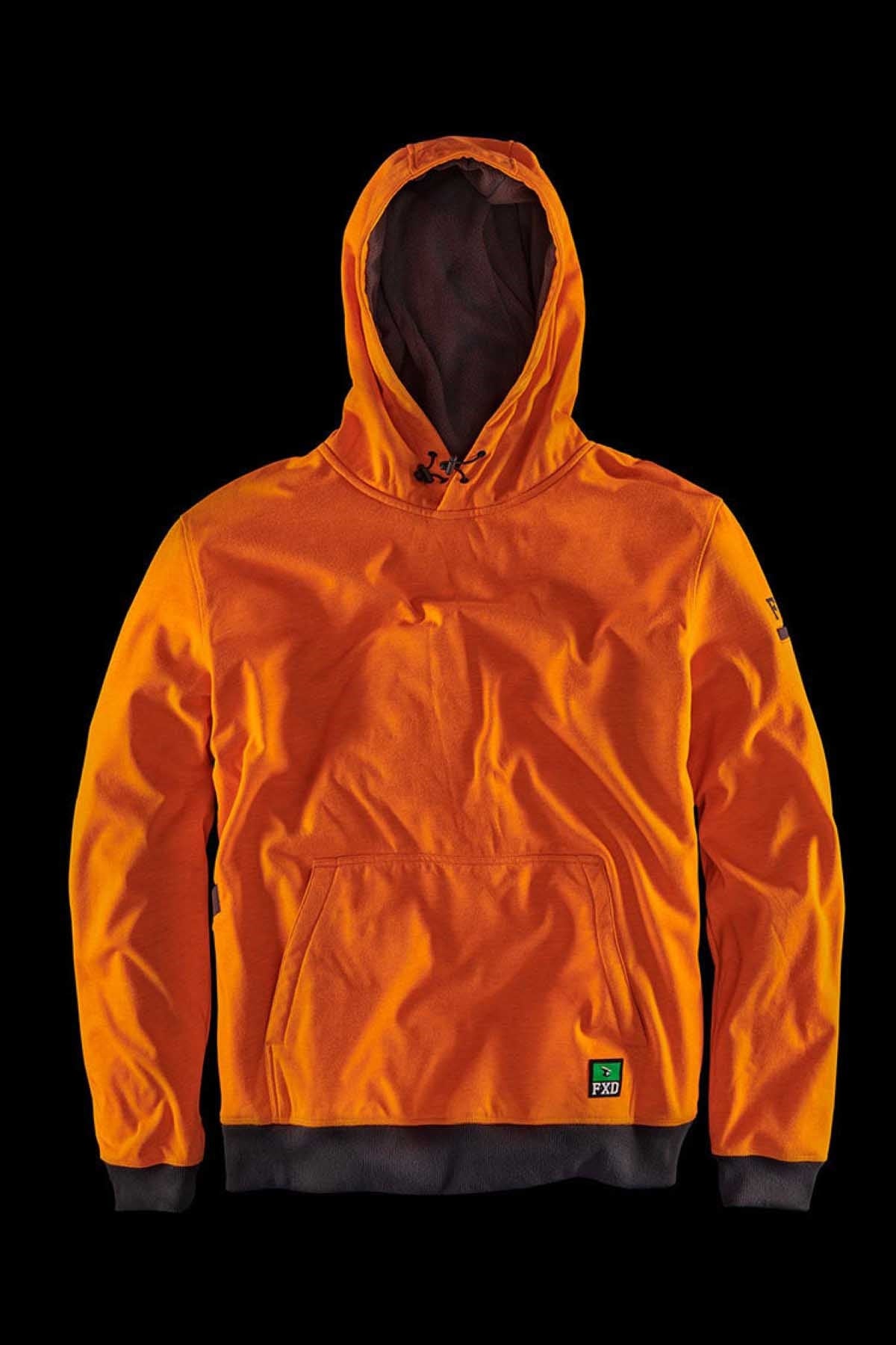 The FXD WF-1 Hoodie, an orange hooded sweatshirt with a front pocket and black interior lining, is displayed against a black background. This water-resistant fleece features a small green and black label near the bottom left hem and a logo at the top center of the hood.