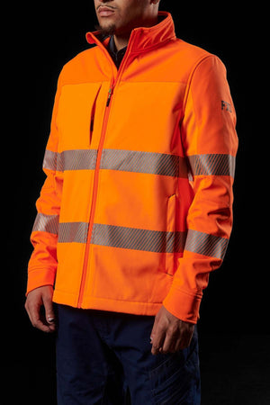 An individual wearing an FXD WO-3T Hi Vis Soft Shell Work Jacket in bright orange high-visibility with reflective horizontal stripes stands against a black backdrop. The 3-layer polyester softshell jacket, zipped up, is breathable, wind-resistant, and water-resistant. The person is visible from the neck down to the waist, with hands resting casually by their sides.