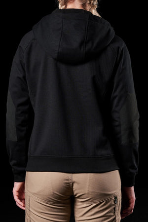 A person is seen from behind wearing the water-resistant FXD Womens WF-3W Jacket in black, paired with beige pants, set against a black backdrop.