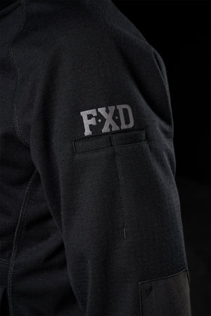 A close-up of the FXD Women's WF-3W Jacket sleeve shows "FXD" near the shoulder. The smooth, water-resistant fabric shines against a dark background, highlighting the texture and detail of this windproof garment.