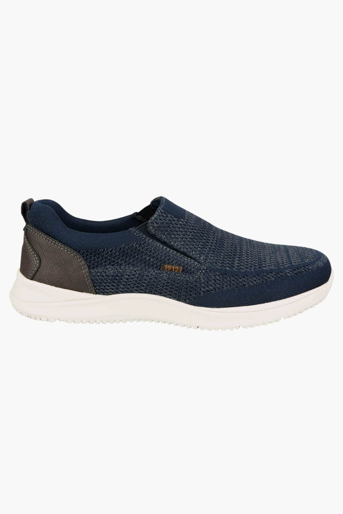 The Florsheim Conway Knit Moc Toe Slip On is a navy slip-on sneaker with a white sole, textured knit upper, small brown "1921" side label, grey heel accent, memory foam insole for comfort, and no visible laces.