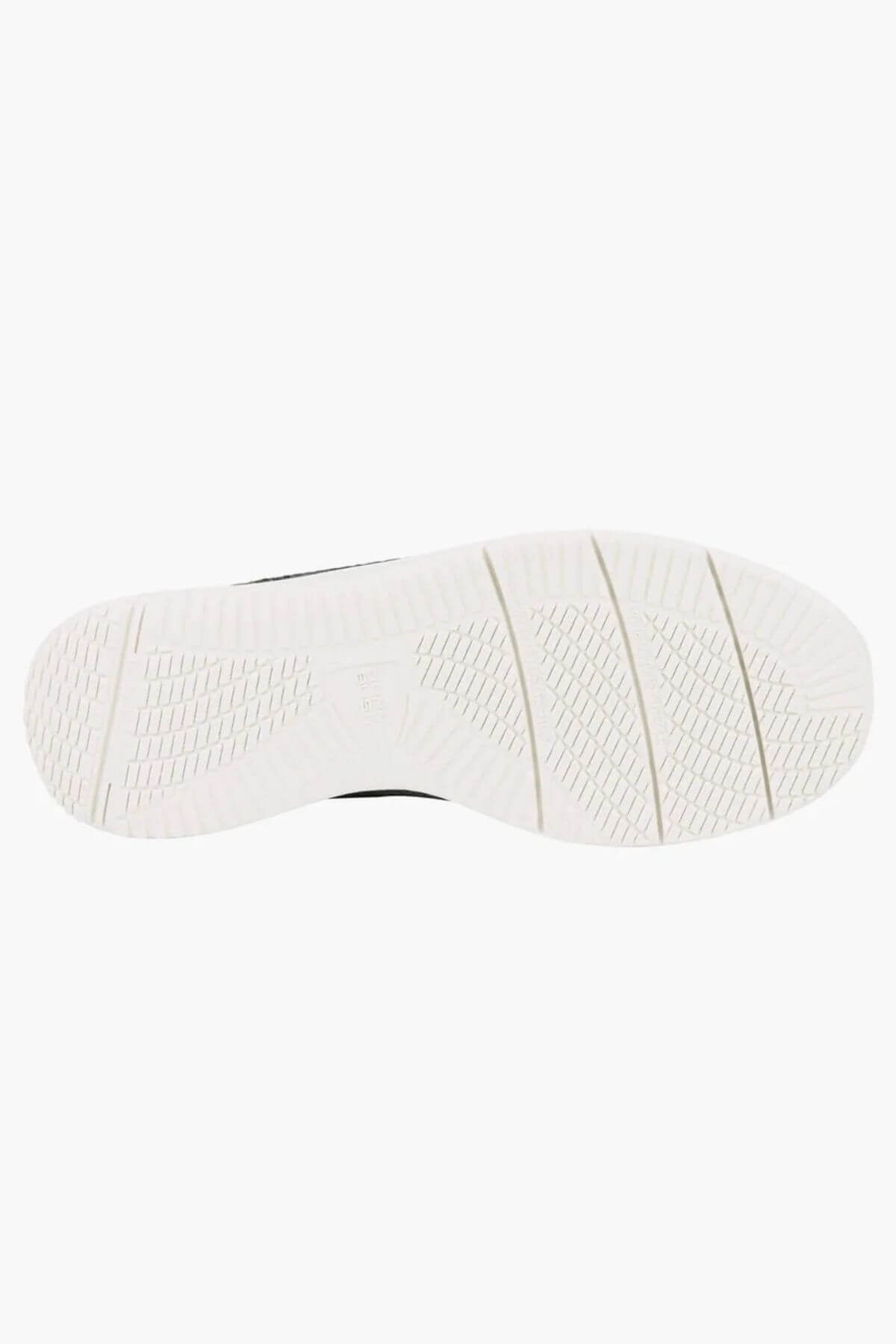 The image shows the white, textured sole of the Florsheim Conway Knit Moc Toe Slip On from below, set against a plain background. The sole displays multiple patterns designed to provide grip and flexibility.