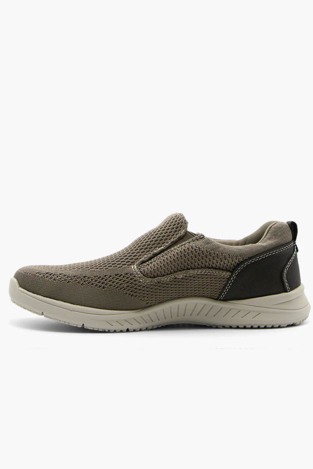 A side view of the Florsheim Conway Knit Moc Toe Slip On, featuring a brown mesh upper, black heel detail, beige lightweight EVA/rubber outsole, and memory foam insole, displayed against a white background.