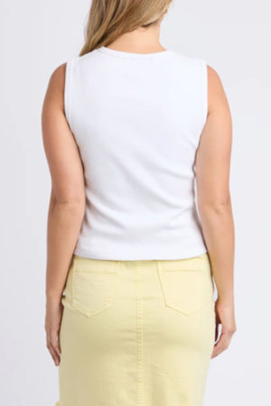 A woman with light hair is seen from the back wearing a Foxwood Raf Button Through Tank in rib fabric and a yellow skirt with pockets, standing against a plain light background for a comfortable fit.