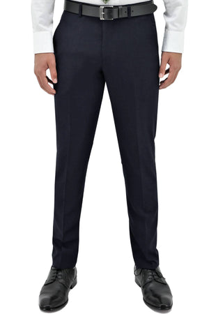 A person wearing Boston Lyon Trouser in dark navy with a comfy fit, paired with a white dress shirt, black belt, and black dress shoes, shown from shoulders down against a white background.