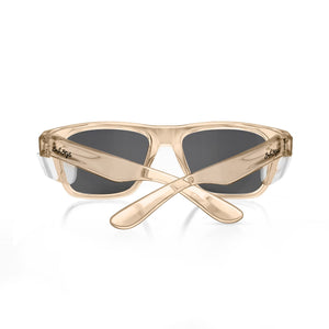The SafeStyle Fusions sunglasses feature Champagne frames and dark polarized lenses for UV protection, with crossed arms showcasing a shiny, smooth finish.
