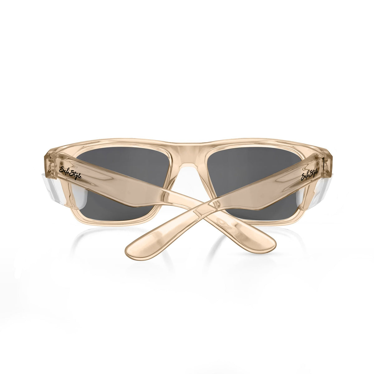 SafeStyle Fusions Champagne Frame Tinted Lens sunglasses shown from the back with crossed arms. The beige, translucent polycarbonate frames feature dark tinted lenses and display the SafeStyle branding near the hinges.