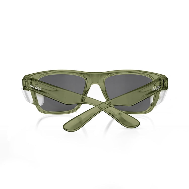 The SafeStyle Fusions sunglasses feature green rectangular polycarbonate frames and dark polarised lenses with a chic, transparent design. With elegantly crossed temples and UV400 protection, these stylish shades ensure safety against a white backdrop.