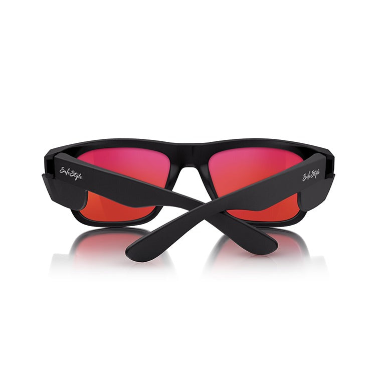 A pair of SafeStyle Fusions with matte black frames and mirror red polarised lenses is displayed against a white background. The sunglasses, featuring the brand name "Style Eyes" written in white on the side of the frames, offer UV protection and crossed arms, seamlessly blending style with functionality.