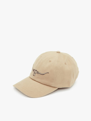 The RM Williams Longhorn Cap boasts a beige, curved-brim design crafted from durable cotton twill. It features a small, dark brown embroidered longhorn steer head on the front, set against a plain white background.