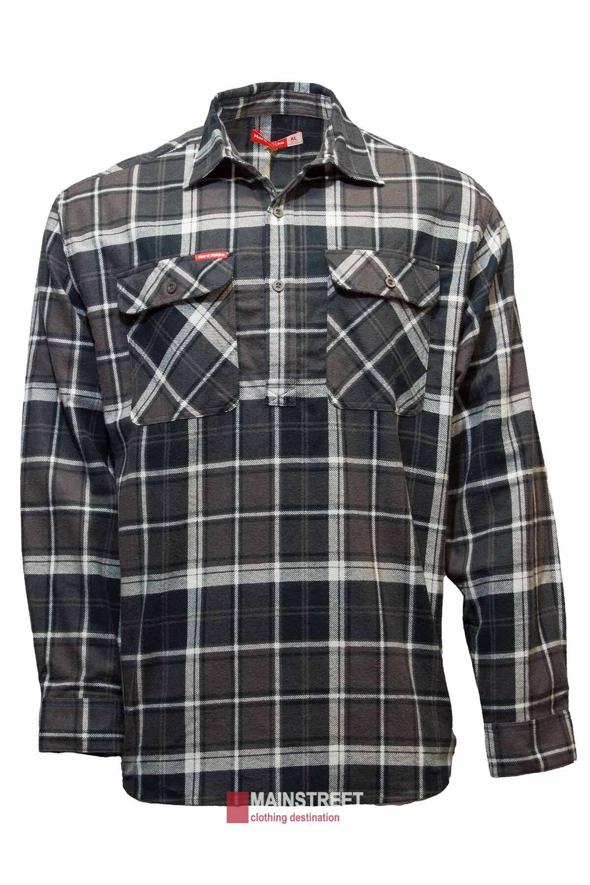 The Hard Yakka Closed Front Check Flannelette Shirt features black and white shades, two front pockets, button closures, and a small "Mainstreet" logo near the collar. This versatile cotton workwear item is showcased on a plain white background.