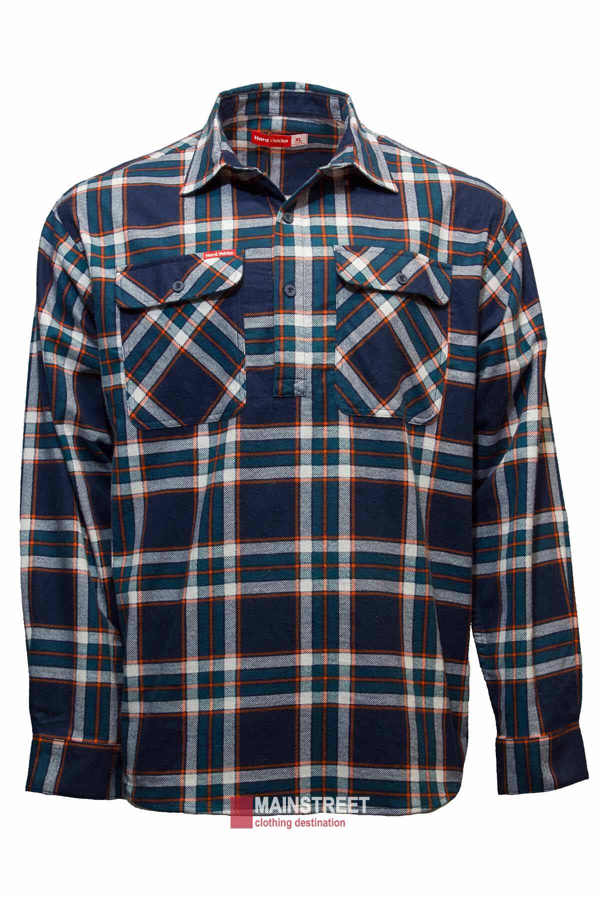 The Hard Yakka Closed Front Check Flannelette Shirt is a long-sleeve, button-up garment featuring a blue, orange, and white plaid pattern. This 100% cotton shirt includes two chest pockets with button flaps and is labeled with a "Mainstreet" brand tag at the bottom.