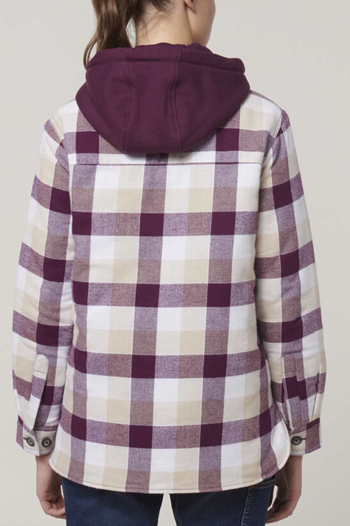 A person is seen from the back wearing the Hard Yakka Women's Quilted Shacket, featuring a purple and beige plaid design with a maroon hood, buttoned cuffs, casual fit, and quilted lining for warmth against a plain backdrop.