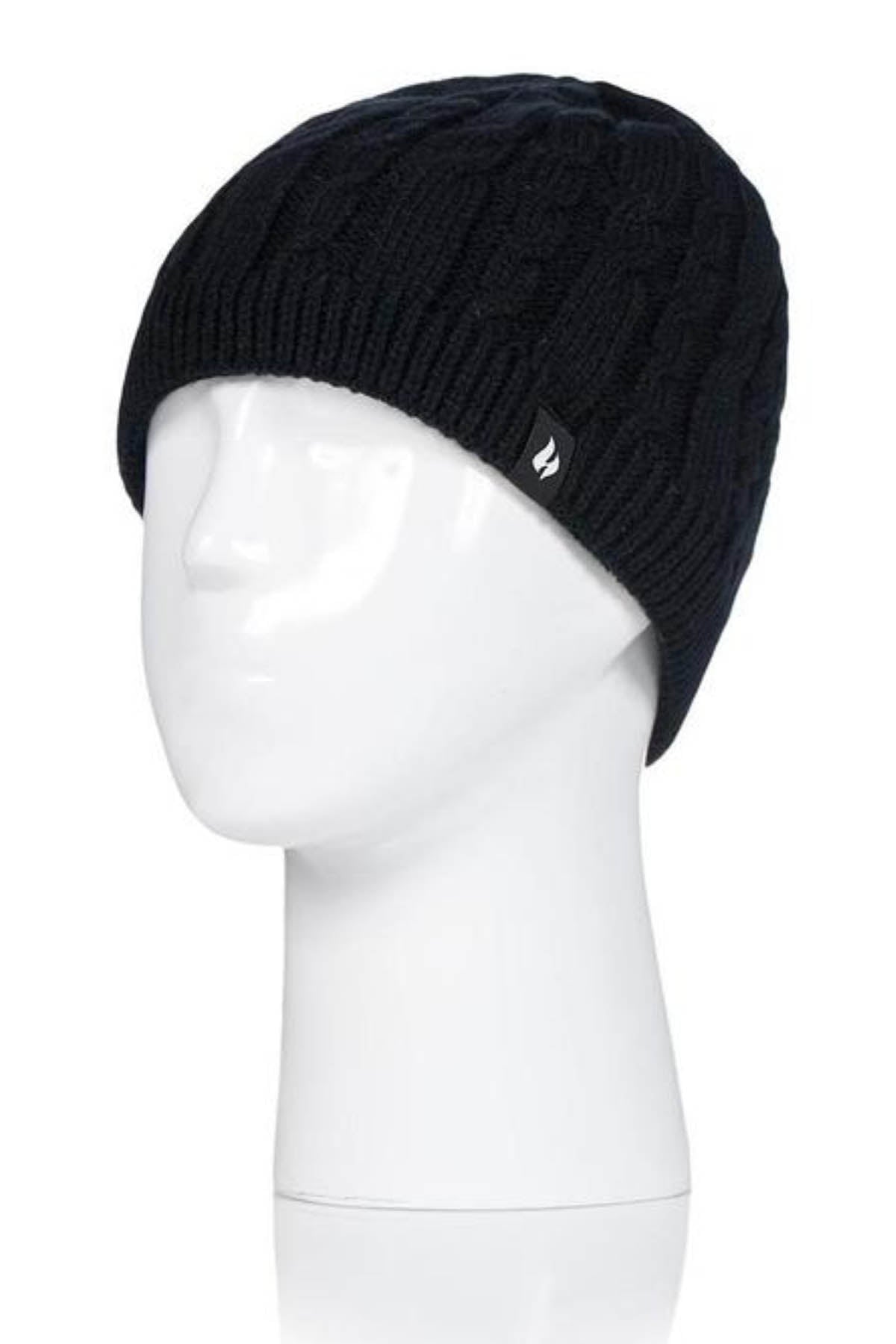 A Heat Holders Alesund Ladies Thermal Beanie, in sleek black and showcasing a chic cable-knit pattern, is displayed on a white mannequin head. This stylish beanie features a small black tag with a white logo on the side and is perfect for cold weather, offering both simplicity and warmth.