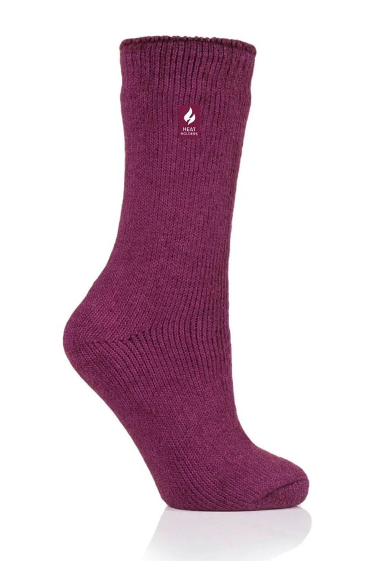 A single Heat Holders Ladies Original Thermal Heat Sock in purple is positioned upright against a white background. It features a ribbed top section and a smooth-textured body. A small flame icon and the word "HEAT" in white highlight its thermal capability, making it ideal for outdoor activities with an impressive TOG rating.