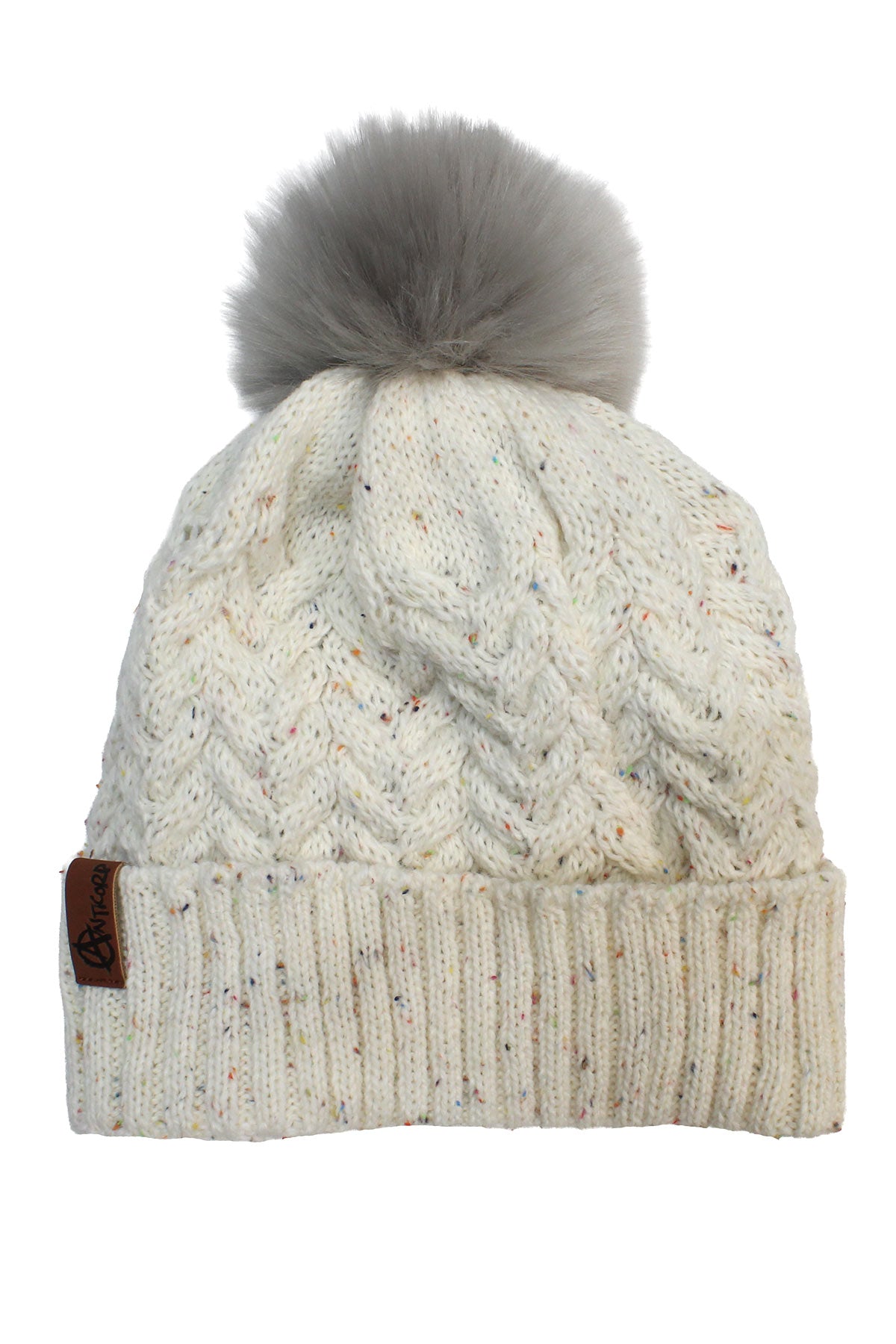 The Anticorp Ladies Plaid Beanie features a cream knit with a cable pattern, wide folded brim, fluffy gray pom-pom on top, and a small brown tag accenting the left side of the brim.