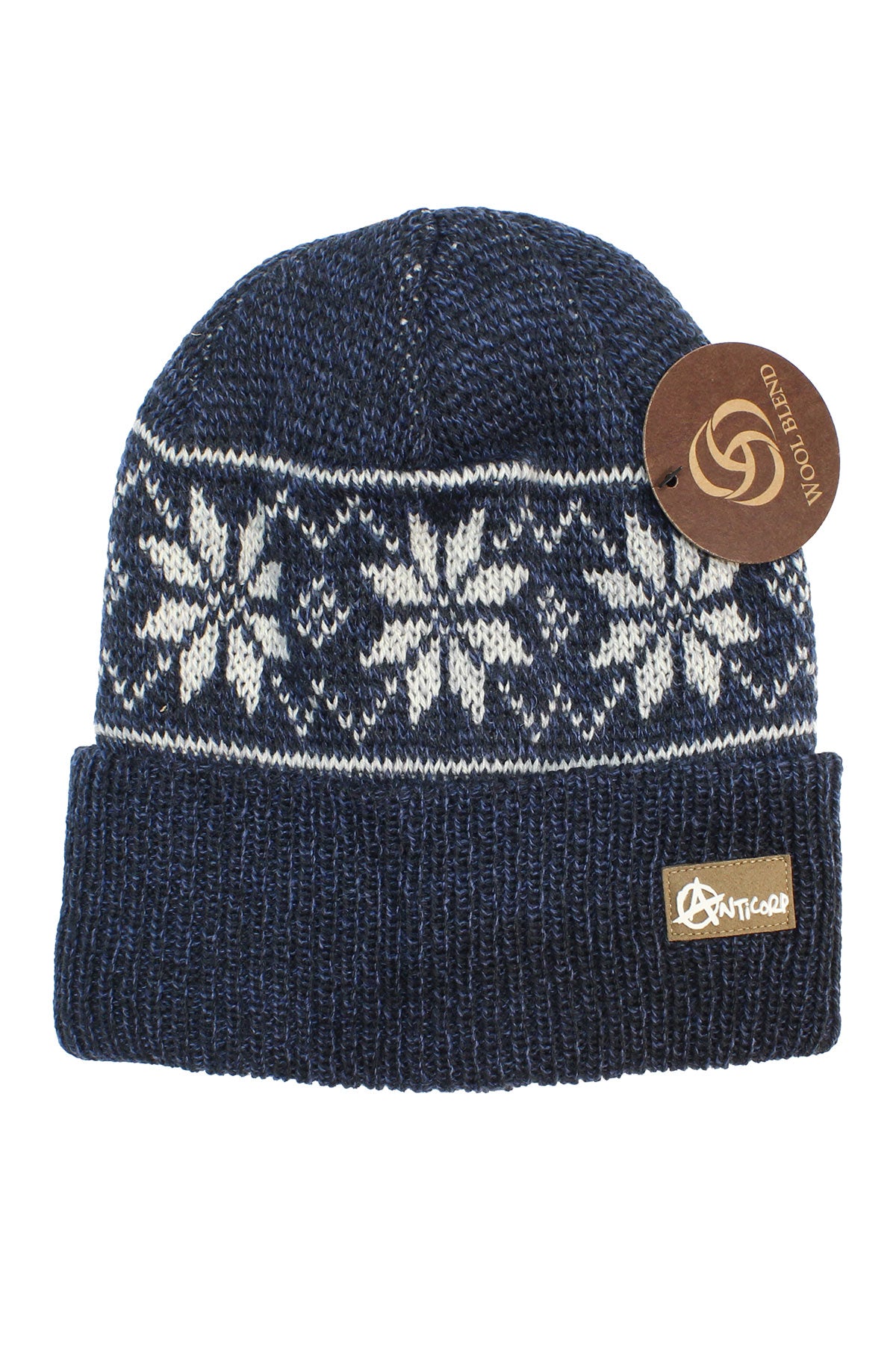 The Anticorp Pattern Beanie is blue and knitted with a white snowflake design, folded brim, and brown logo tag. It features a round paper tag near the top with a spiral motif and “CONSCIOUS LOOM”—ideal for winter wear.