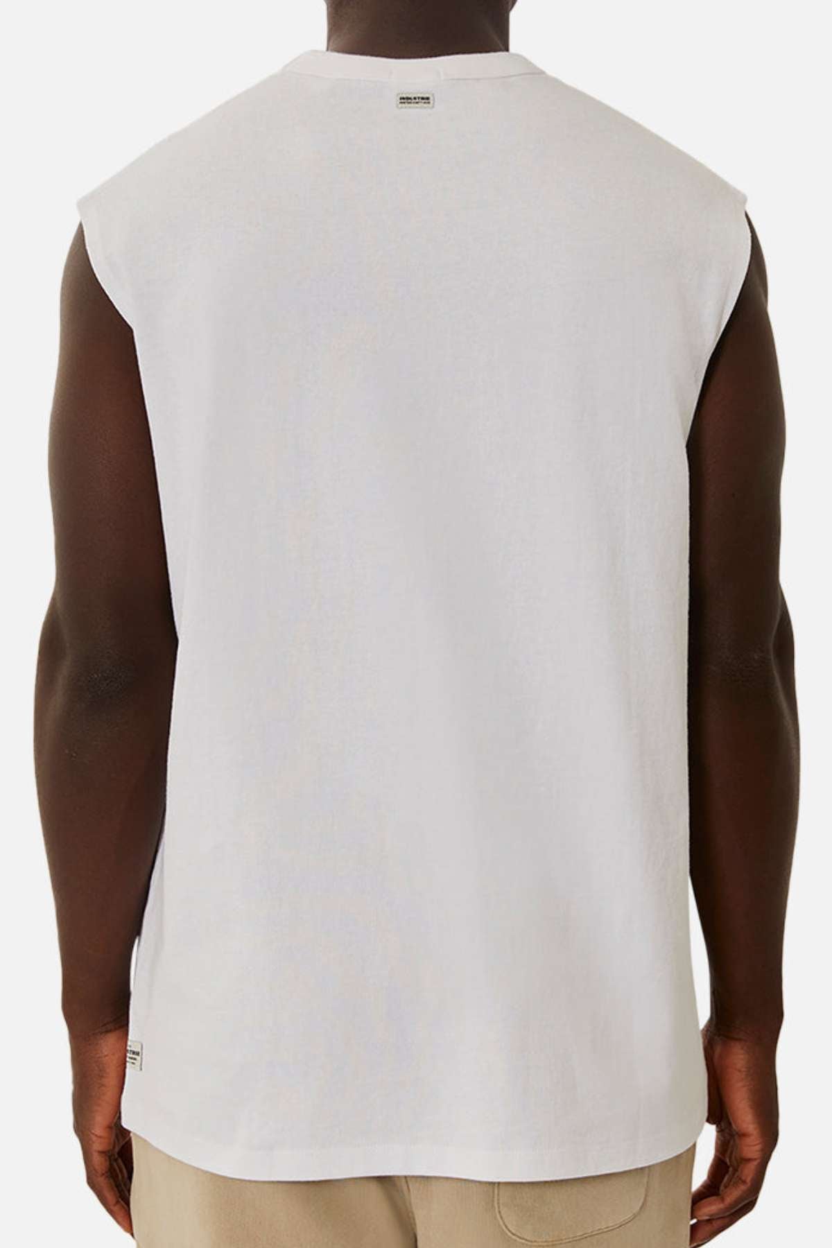 A person is shown from behind wearing the Industrie The Del Sur Sleeveless Tee in white with beige pants, standing against a plain white background.