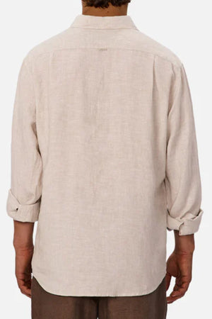 A person is seen from behind wearing the Industrie The St Martins Shirt, a light beige lightweight linen shirt with rolled-up sleeves, standing against a plain white background.