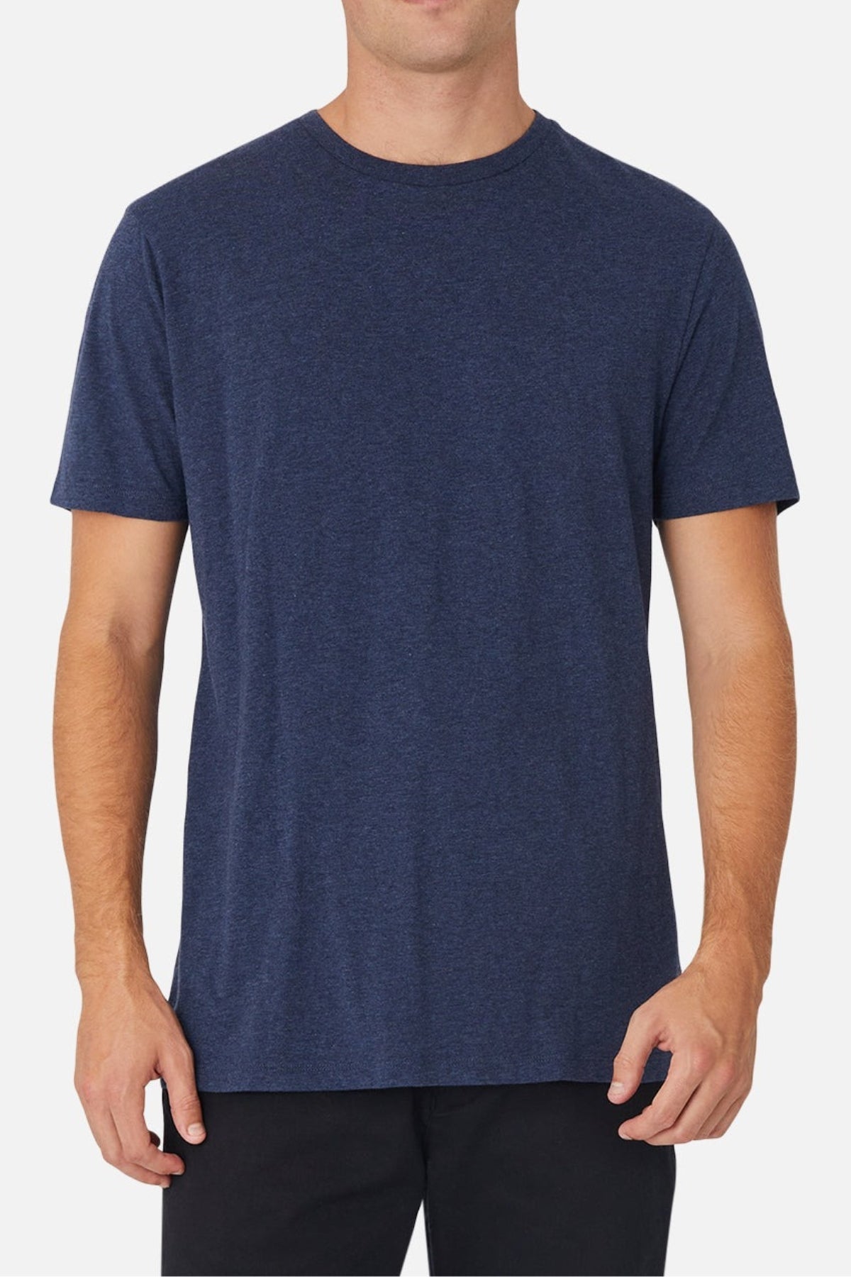 Wearing the Industrie The Basic Crew Tee in dark blue and black pants, a person stands against a white background, with their head partly out of frame.