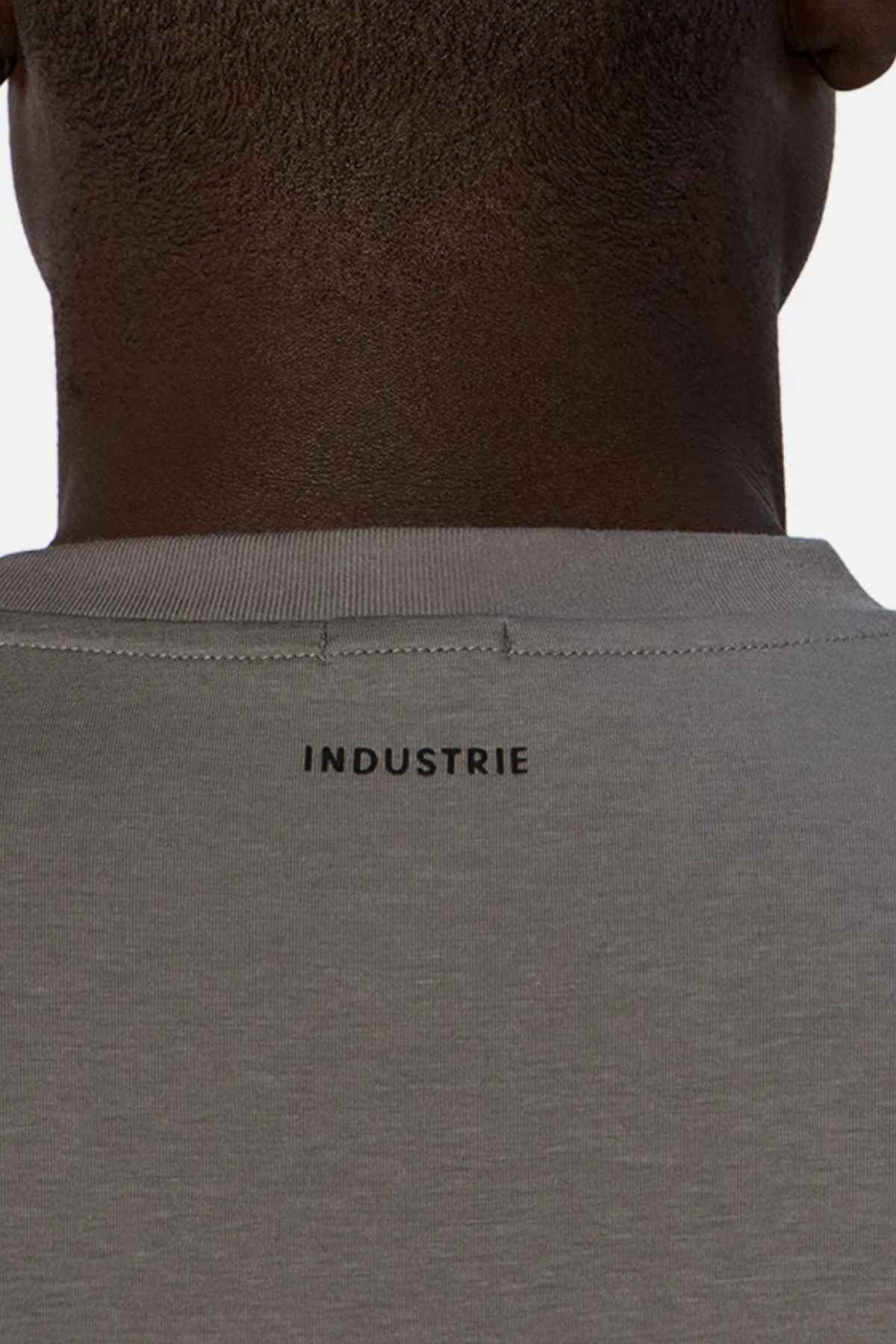 Back view of a person wearing the relaxed-fit Industrie The Freeman Athletic Tee in gray. The iconic "INDUSTRIE" branding prominently adorns the top center of the back, showcased against a plain background.