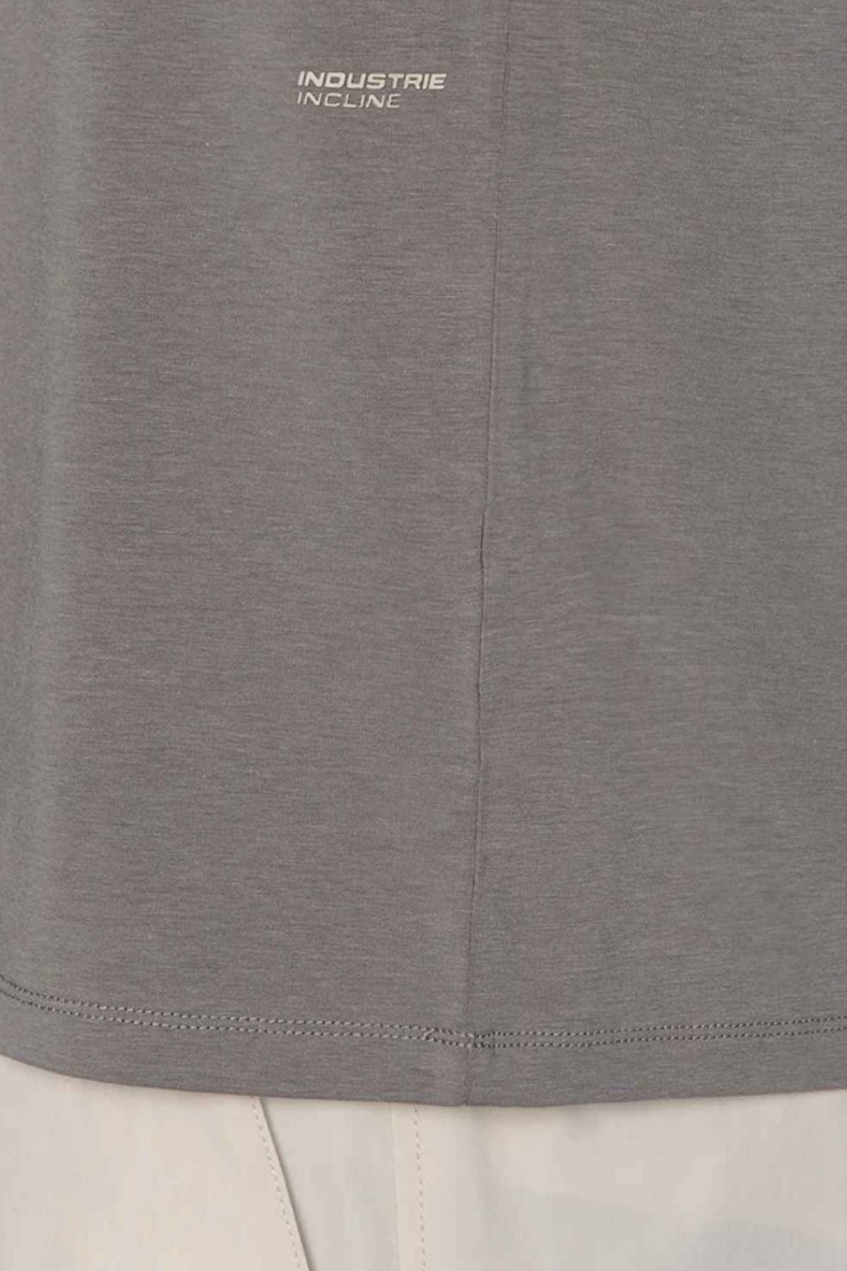Close-up of the lower part of the Industrie The Freeman Sleeveless Tee in gray with "INDUSTRIE INCLINE" printed near the hem, paired with light-colored pants visible at the bottom.