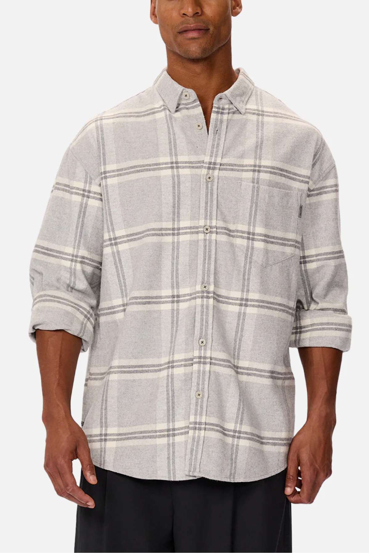 A man wears the Industrie The Gloucester Shirt—a relaxed-fit, light gray plaid button-up with rolled sleeves and a chest pocket—made from 100% cotton, standing out against a plain white background.