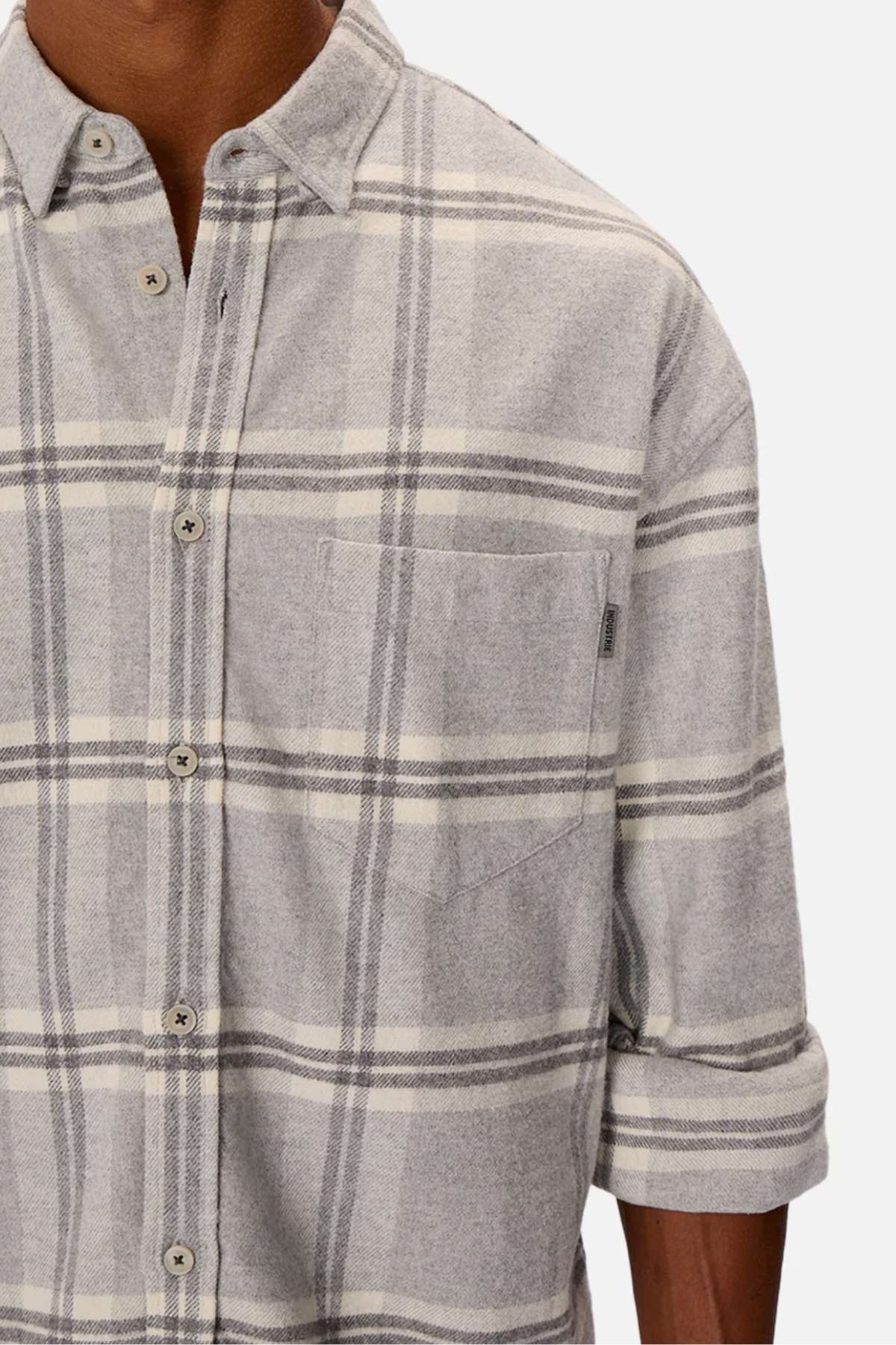 A person wears the stylish Industrie The Gloucester Shirt in light gray plaid with rolled-up sleeves, a chest pocket, and light buttons. Made from 100% cotton, it's presented on a plain white background.