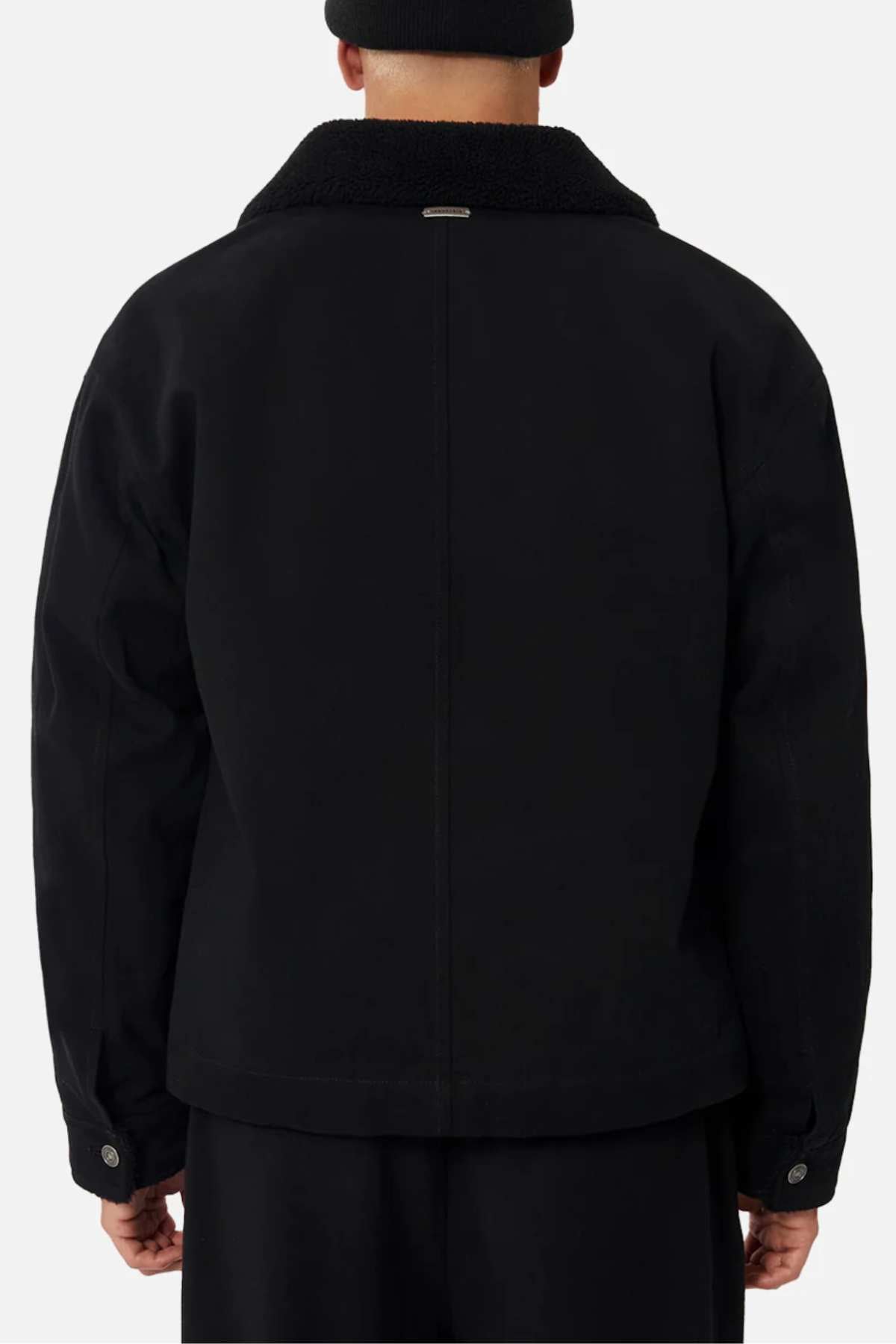 A person in a black beanie and the Industrie The Huntsville Jacket with a sherpa lining is shown from the back against a plain light background.