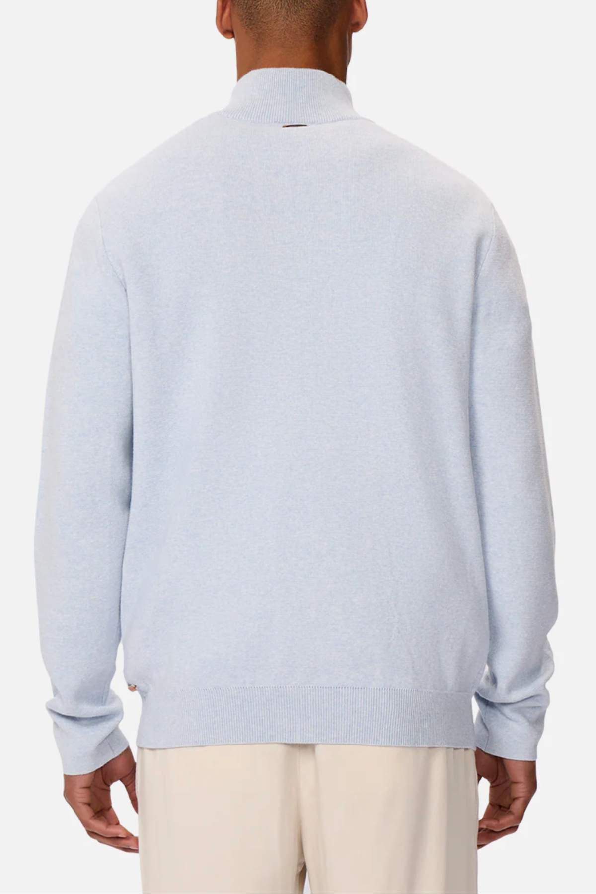 Someone wearing the Industrie The Lakewood Zip Neck, a light gray regular fit sweater, and cream-colored pants is seen from the back against a plain white background. The cotton jumper has a simple design with ribbed collar, cuffs, and hem.