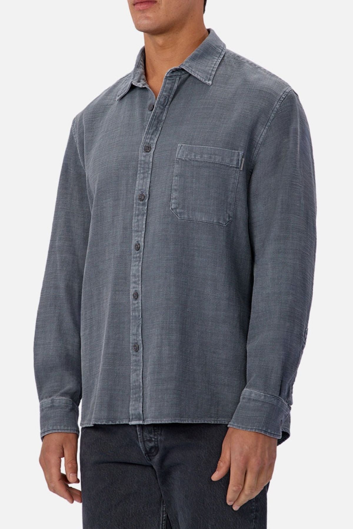 A person wearing the Industrie Lisbon Long Sleeve Shirt, made from 100% cotton with a chest pocket and classic collar, paired with dark jeans, stands against a plain light background.