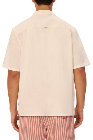 A person is shown from the back wearing the Industrie The Marbella Short Sleeve Shirt in off-white and red-and-white vertically striped shorts against a plain background, capturing a casual everyday style with their head partially visible.