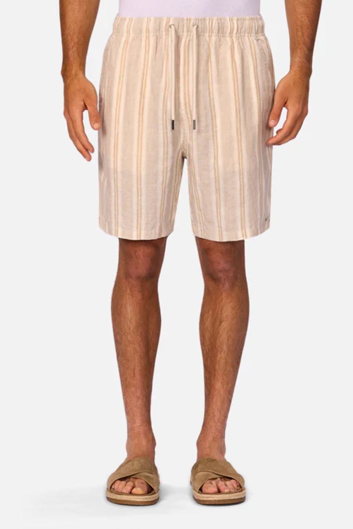 Wearing Industrie The Matias Short in beige and white stripes with tan slide sandals, the person stands against a plain white background. Image is cropped from mid-torso to feet.