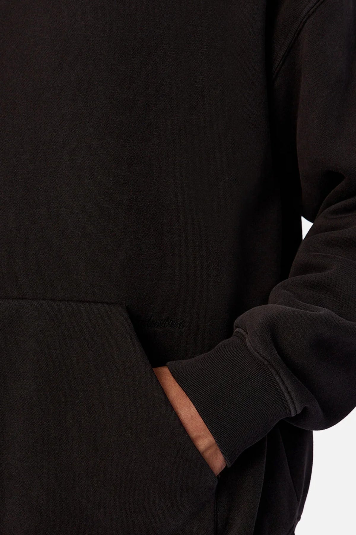 Someone wearing the Industrie The New Del Sur Fleece Hoodie with their right hand in the front pocket. Only part of their torso and arm are visible against a plain background.