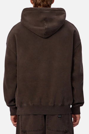 A person is seen from behind wearing an Industrie The New Del Sur Fleece Hoodie in dark brown with the hood down and matching pants. The loose-fit hoodie has ribbed cuffs and hem, set against a plain, light background.
