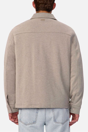 A person is shown from the back, wearing the Industrie The New Westport Jacket and light blue jeans, standing against a plain white background.