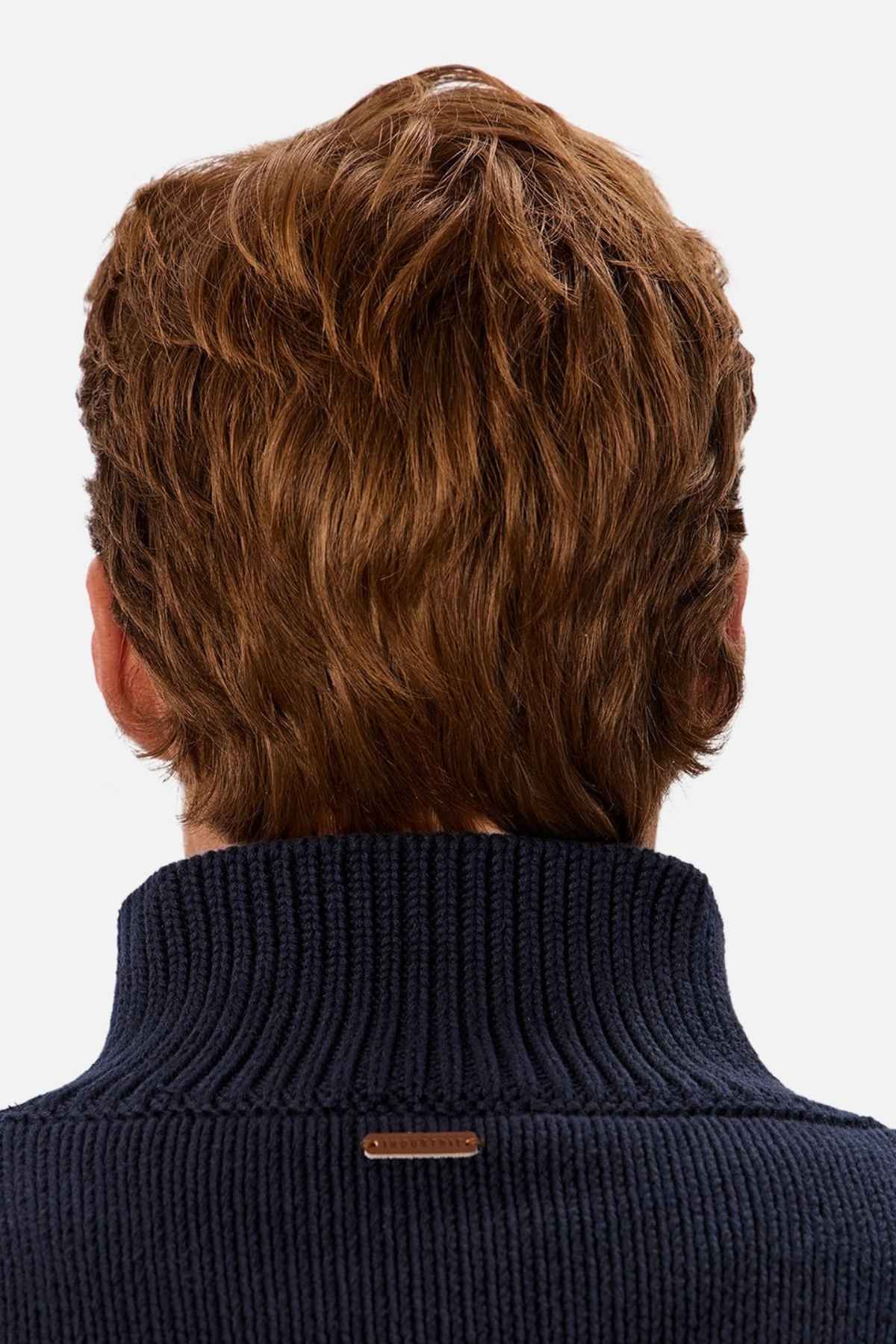 A person with short, neatly cut wavy brown hair is seen from the back, wearing a timeless Industrie The Osbourne Zip Neck Knit sweater made of 100% cotton. The black sweater features a small metallic tag near the neckline, set against a plain white background.
