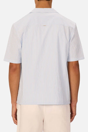 A man wearing the Industrie The Sorrento Short Sleeve Shirt in blue and white pinstripes.