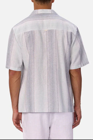 A man wearing the Industrie The Sunset Short Sleeve Shirt in white for a relaxed, casual look.