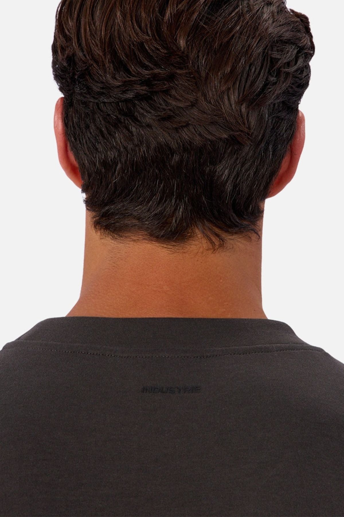 A close-up of a person’s head and neck with short, dark hair, wearing the Industrie The Tech Del Sur Sweat. The image highlights the upper back and neck area, emphasizing comfortable activewear.